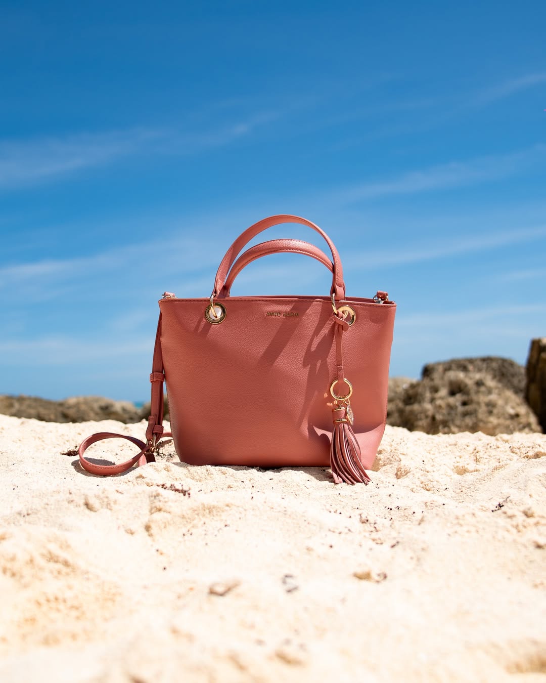 Olukin — Pink leather tote on a Barbados beach